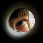 View of a child looking out a keyhole, limiting what can be seen
